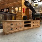 An old piece of workshop furniture transformed into a TV stand