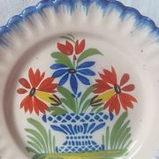 Pair of antique plates in popular earthenware with a floral basket decoration on the edge.