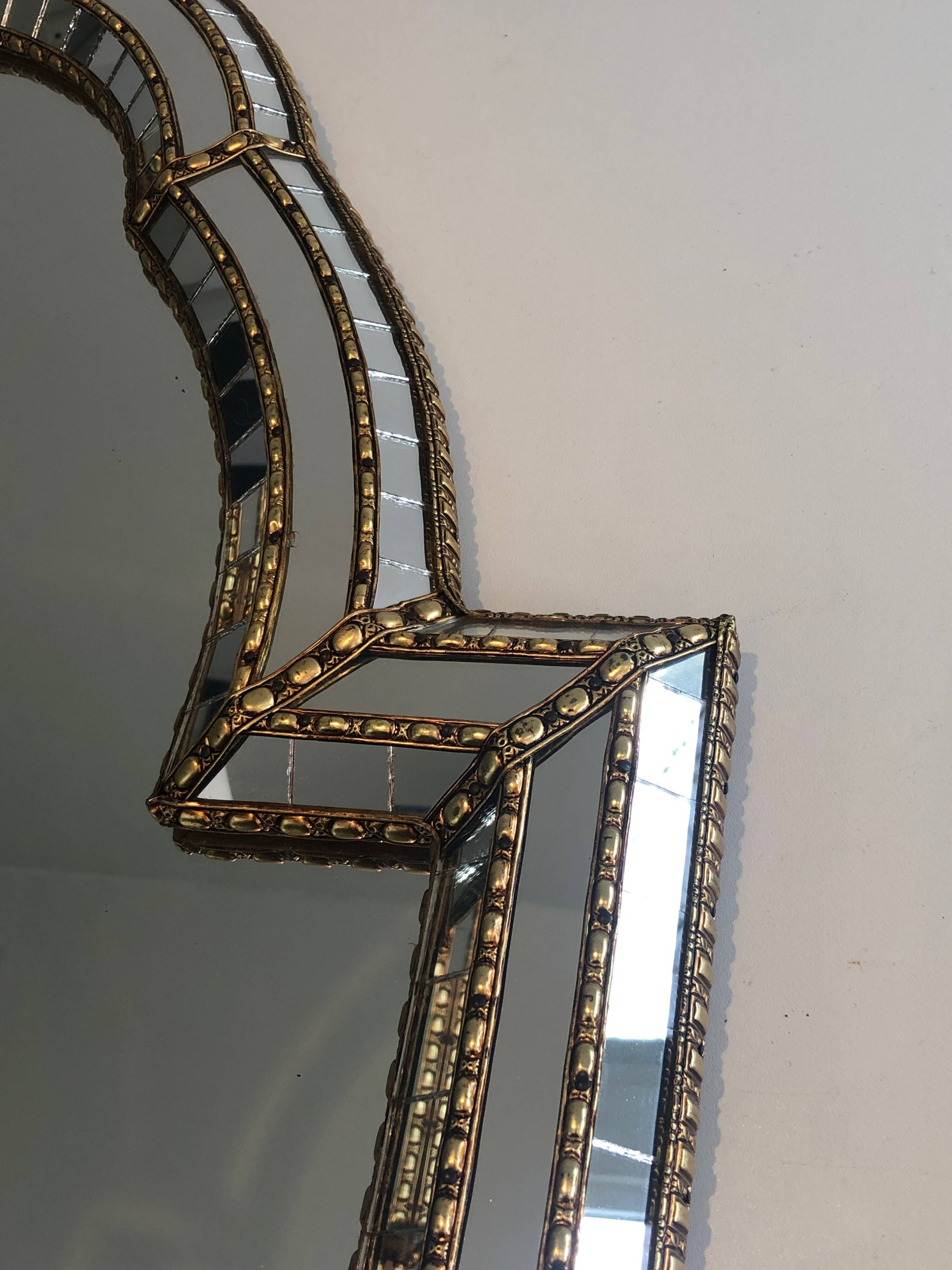 Multi-faceted mirror and brass garlands