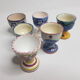 Lot of six enamelled ceramic cockroaches with Mediterranean themed decorations