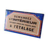 Old enamelled plate of a hardware store