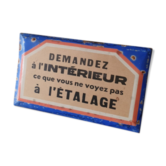 Old enamelled plate of a hardware store