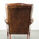 Wingback armchair made of sheepskin leather finished with decorative nails
