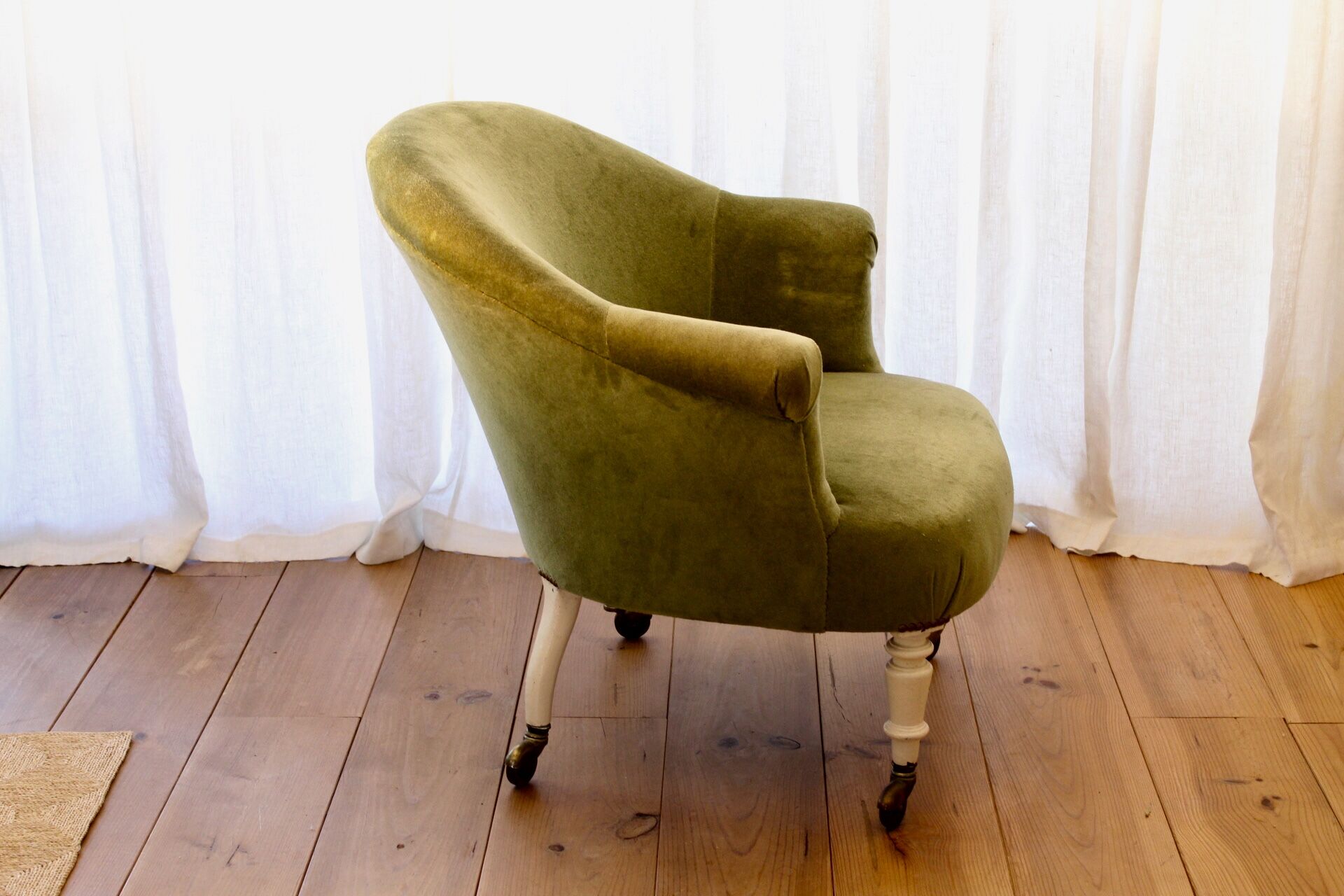 Toad in almond green velvet armchair on castors