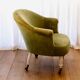 Toad in almond green velvet armchair on castors