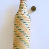 Glass and wicker bottle