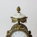 Clock and pair of Louis XVI style candelabras.