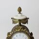 Clock and pair of Louis XVI style candelabras.
