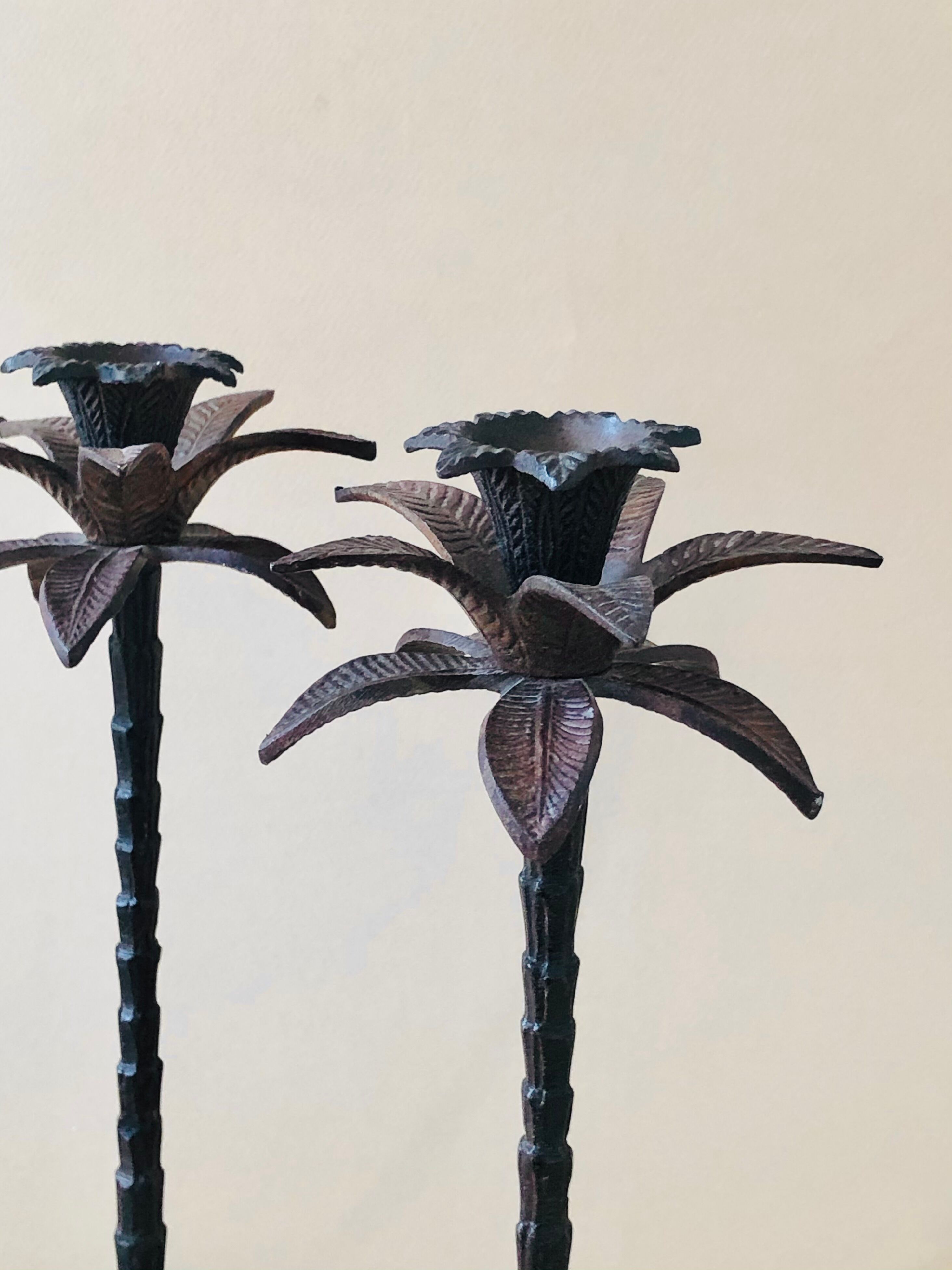 Pair of patinated metal candlesticks