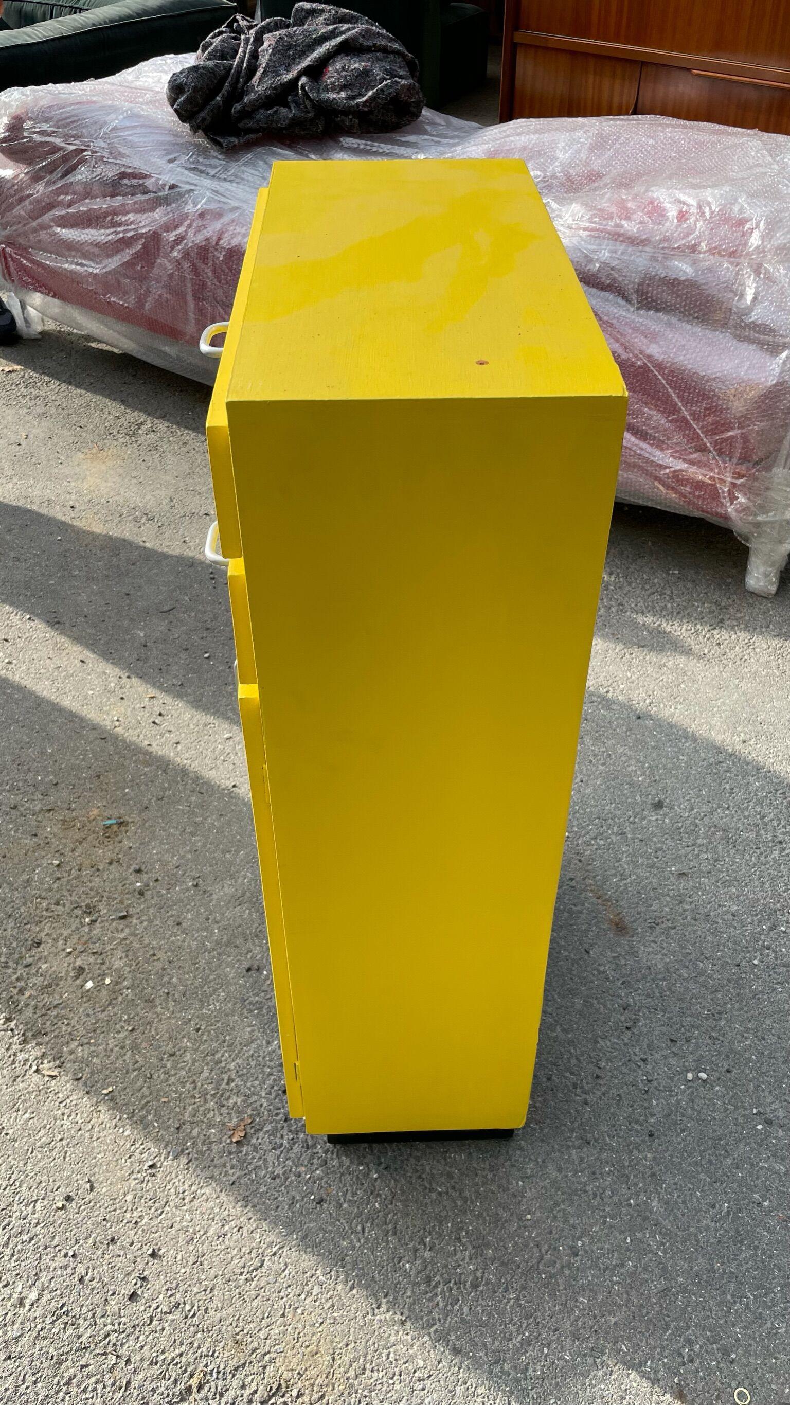 Yellow wooden chest of drawers