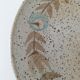 Speckled stoneware plate with floral decoration
