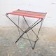 Vintage folding stool with a bayadère fabric pattern.
