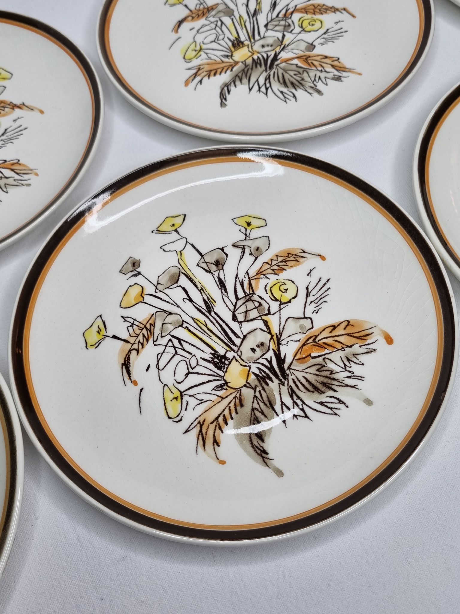 Six vintage dessert plates decorated with flowers from the Gien earthenware factory
