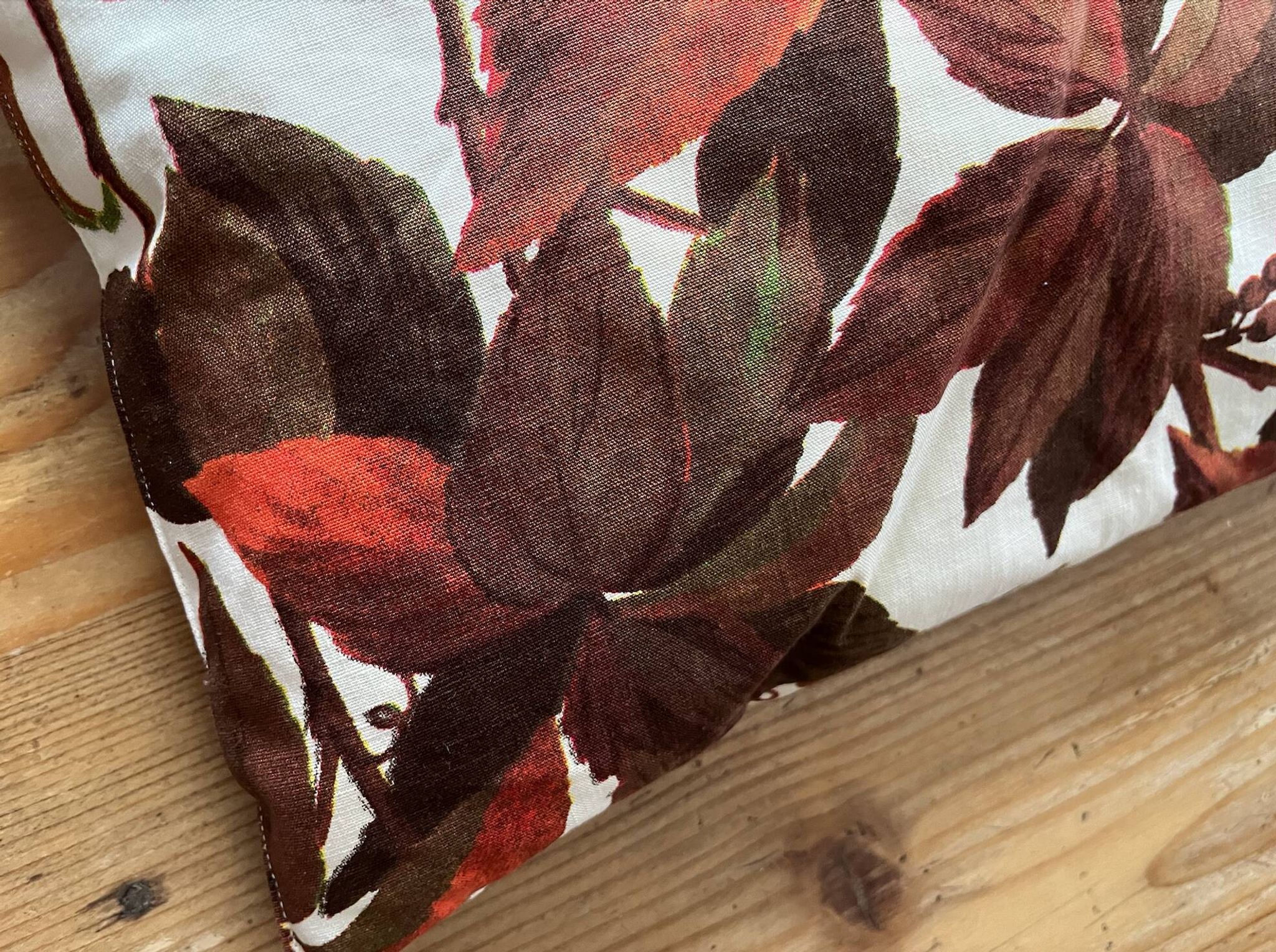 Vintage cushion with virgin vine leaf pattern.