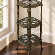Italian side table with three openwork shelves in patinated metal.