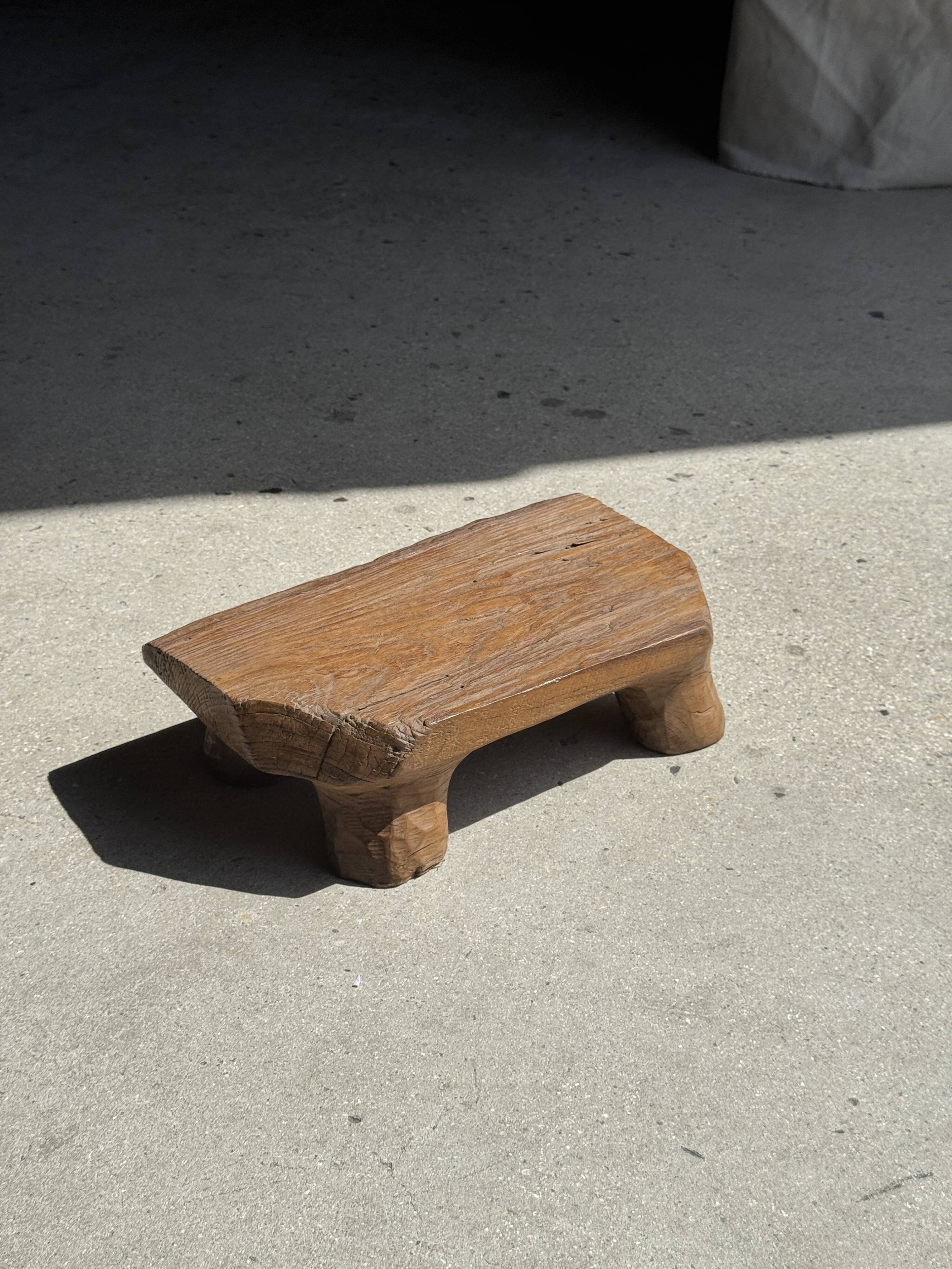 Small stool, teak footrest with short cut corners.