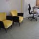 Pair of vintage 1950s cocktail chairs in yellow velvet and black faux leather, wooden frame.