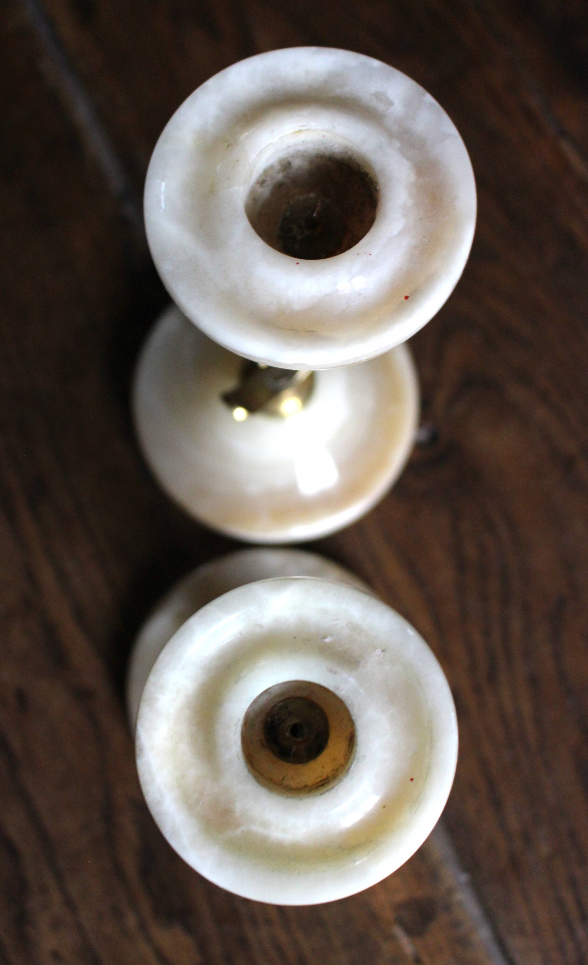 Pair of curved brass candlesticks with onyx