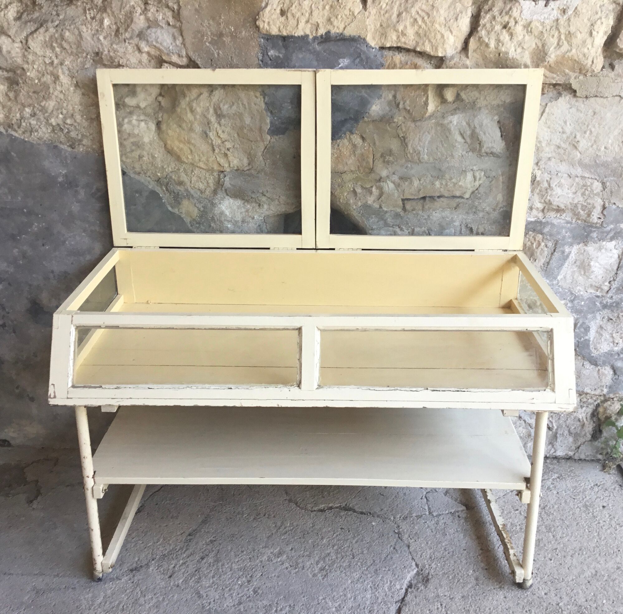 Old showcase on tubular metal feet - early twentieth century