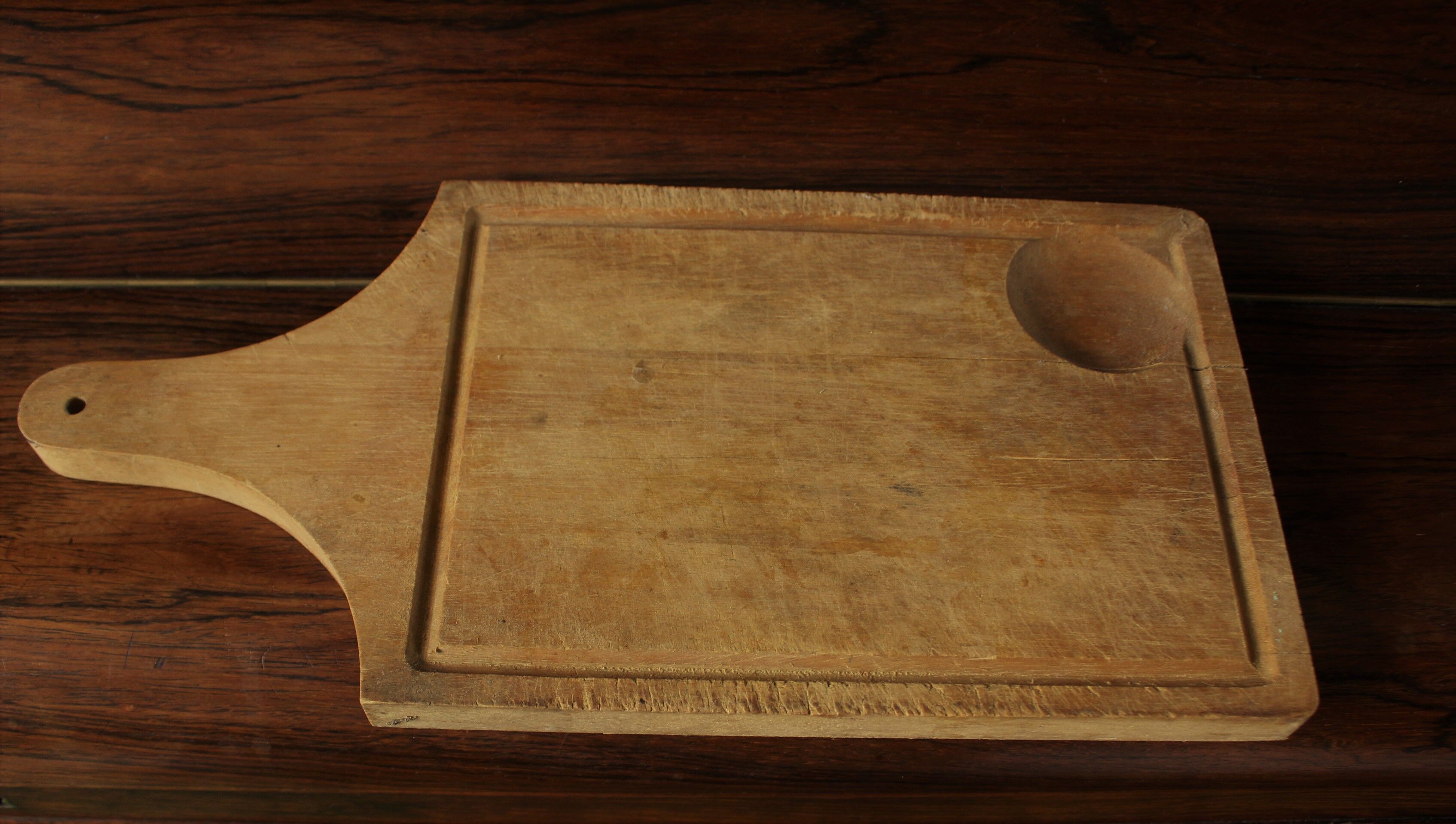 Wood cutting board with groove and handle