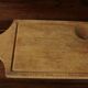 Wood cutting board with groove and handle