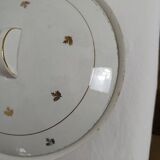 White earthenware soup tureen with a golden pattern.