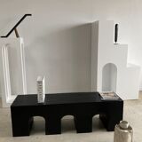 Black solid monoxyl wood bench carved into 3 arches