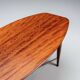 Assymetrical coffeetable with glass storage and cross leg details