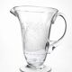 Antique glass pitcher with wheel engraving and floral decoration, Bohemia, early 20th century.