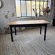 Oak farmhouse table with turned black legs.
