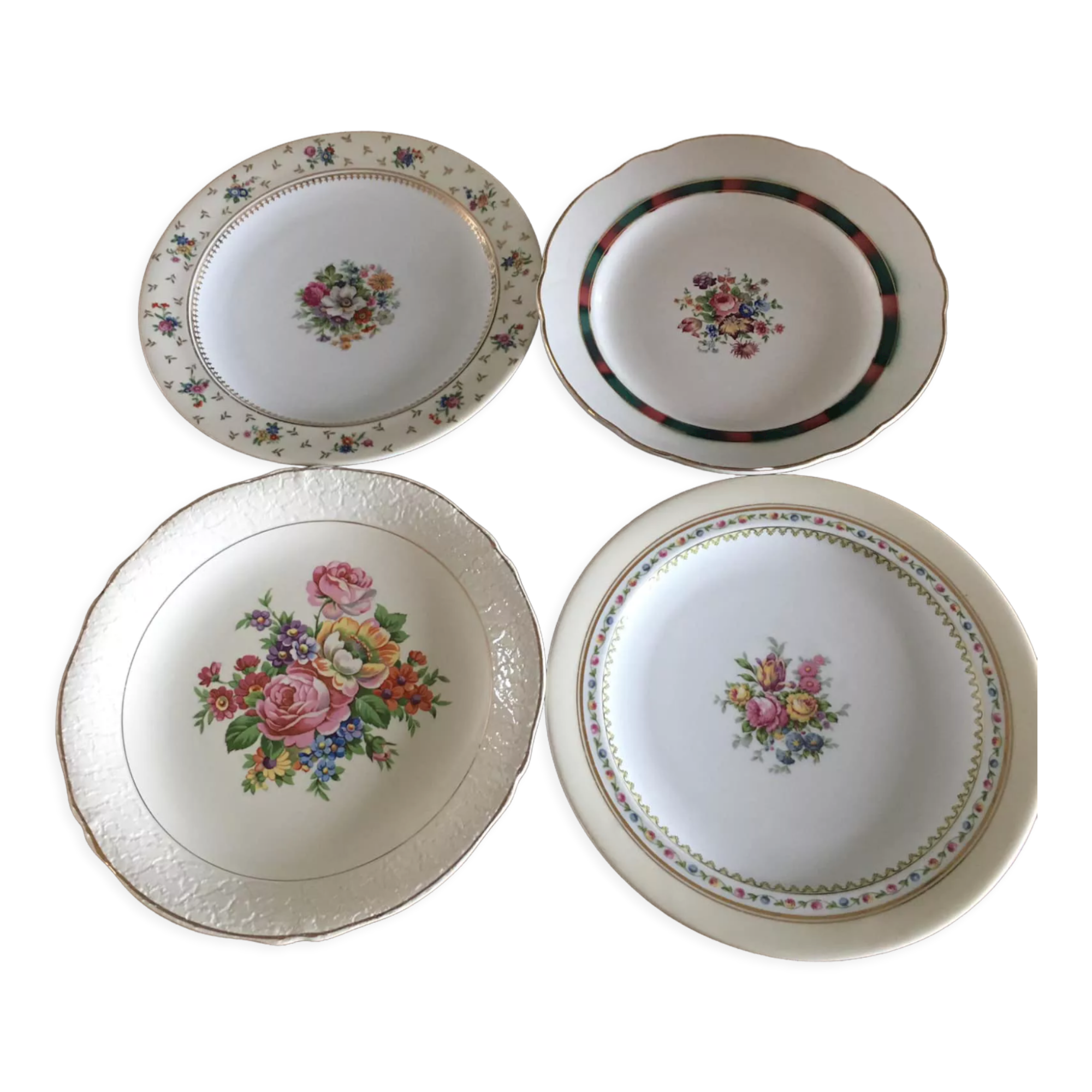 4 mismatched flat plates with floral patterns. Porcelain. Stamped