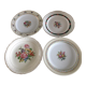 4 mismatched flat plates with floral patterns. Porcelain. Stamped