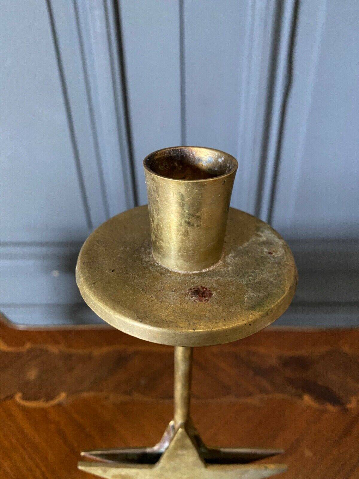 Pair of brass candlesticks decorated with 20th century stars