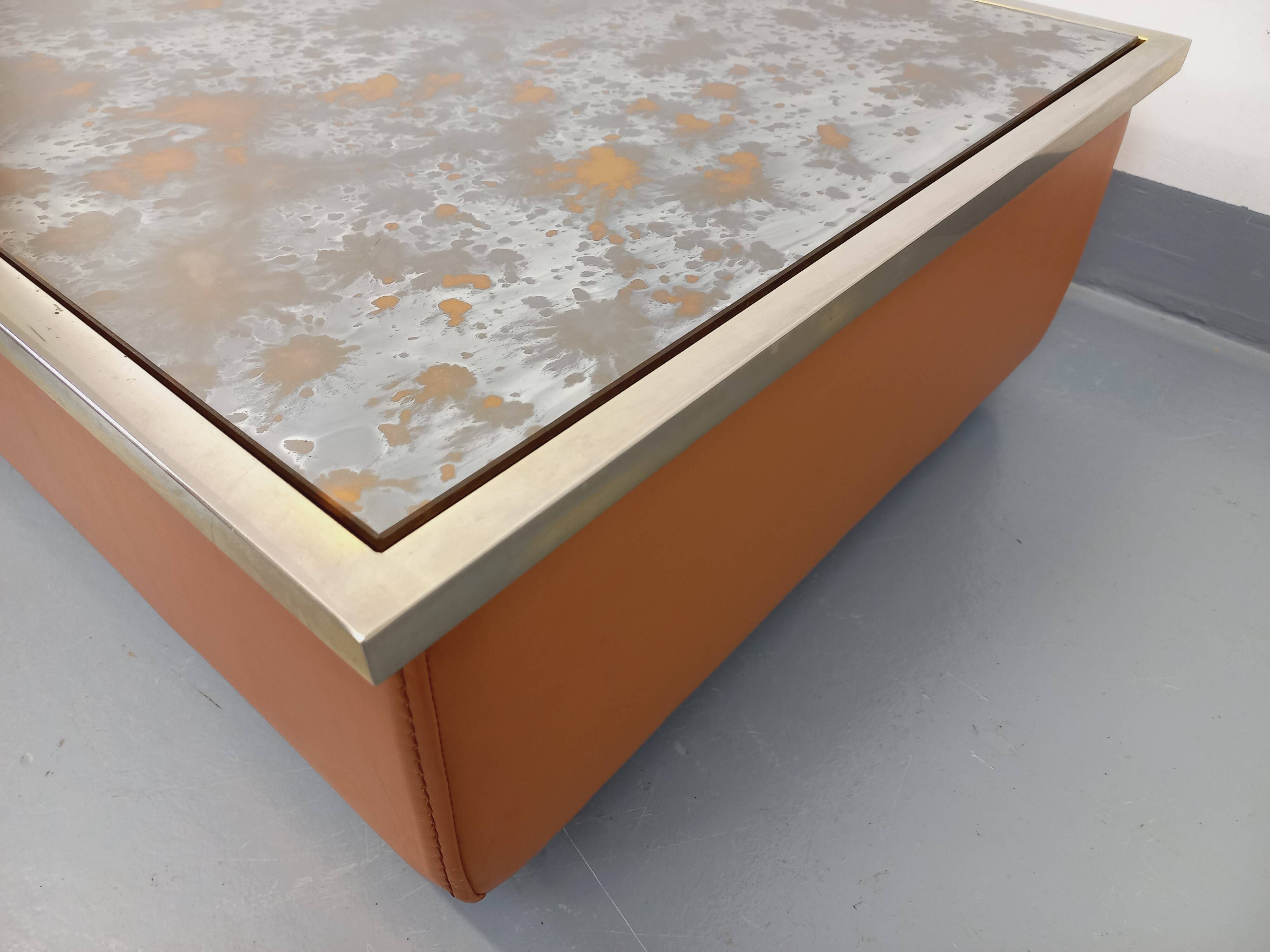 Vintage coffee table in églomisé glass, chrome and leather from the 70s
