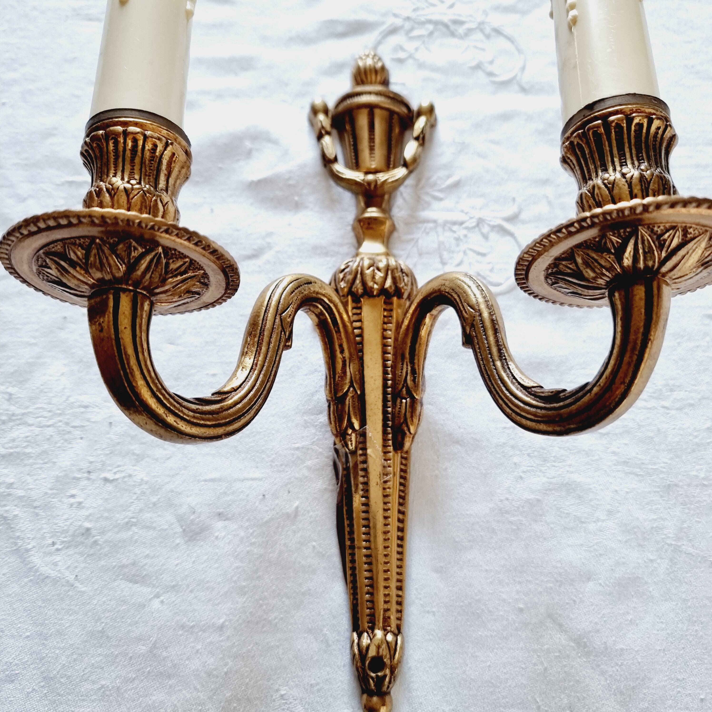 French Empire-style wall sconce or chandelier in bronze with an antique gold patina.