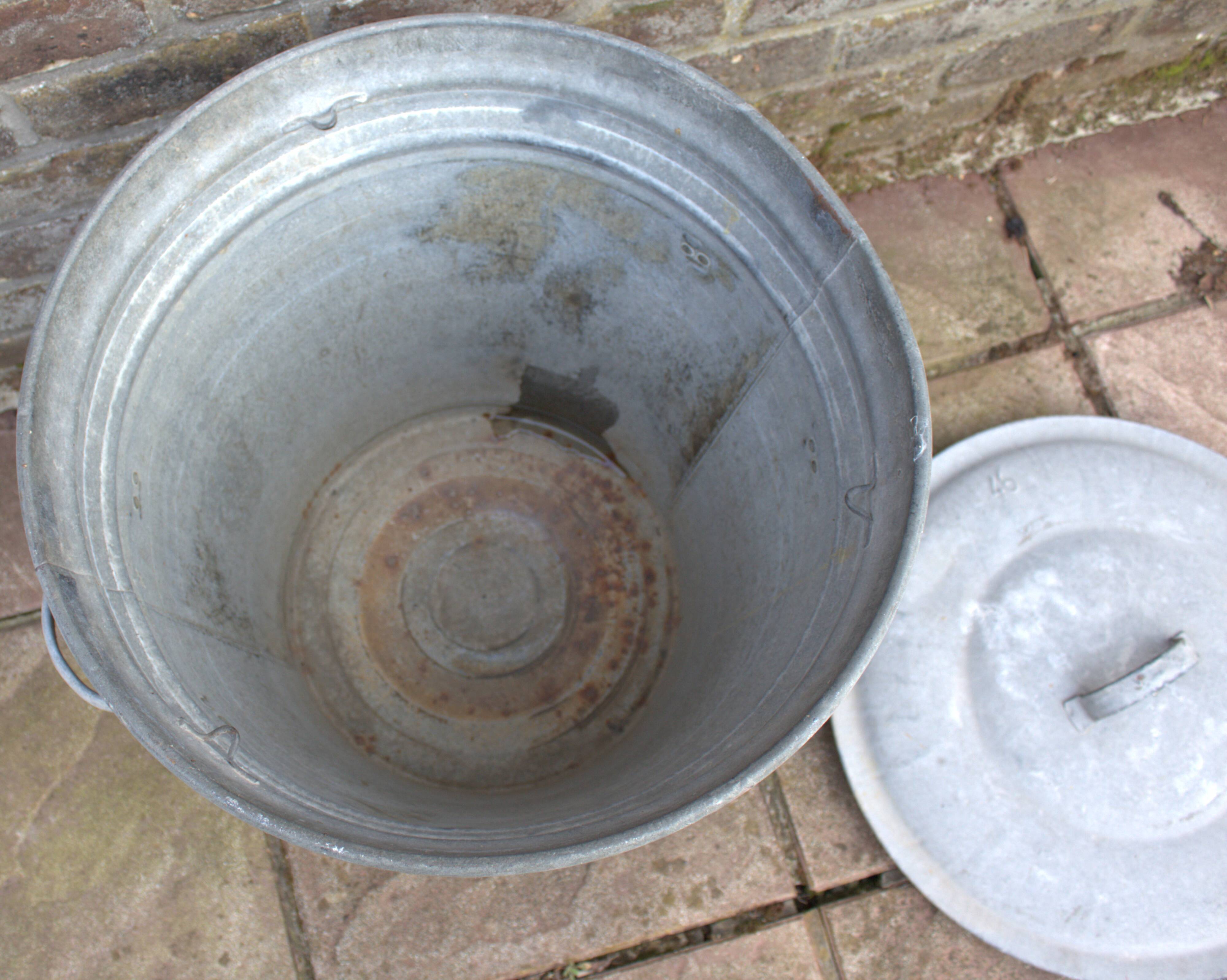 Old galvanized zinc trash can with lid