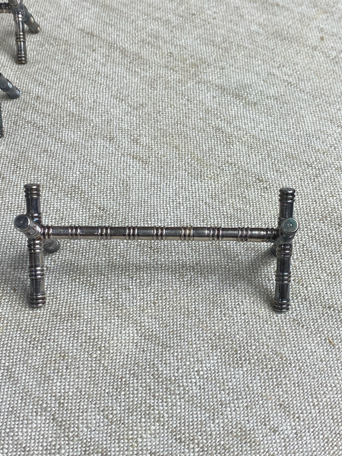 Six bamboo-patterned metal silver-plated knife rests.