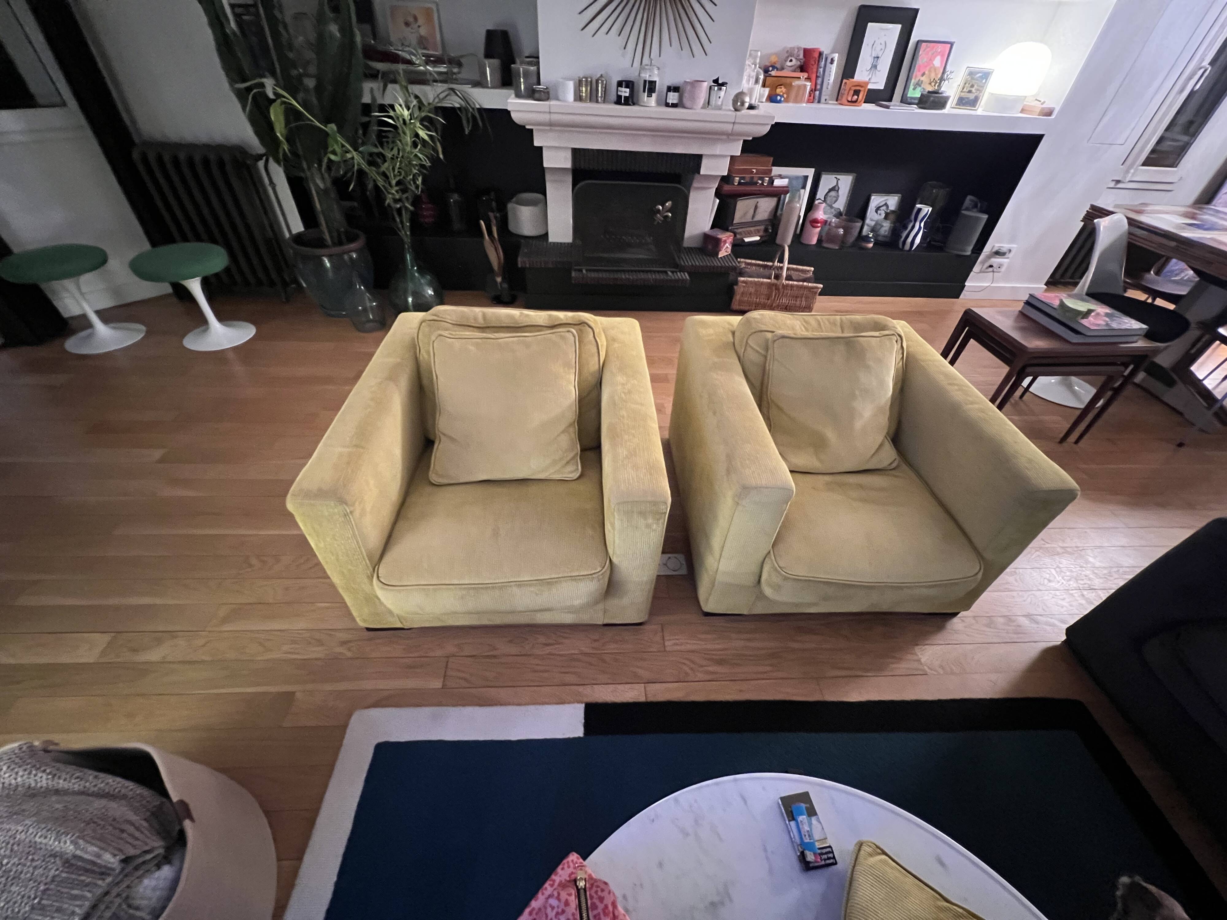 Two yellow Roche Bobois Longislande armchairs.