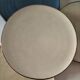 Set of 6 cream and grey-blue glazed earthenware plates.