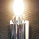 Transparent and white glass torch-type wall light.