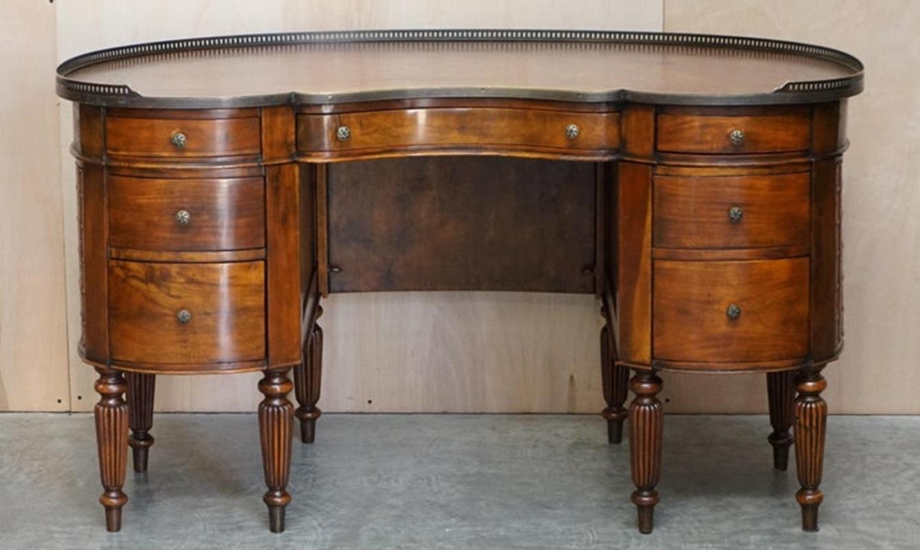 Regency style hardwood and leather kidney desk with gallery.