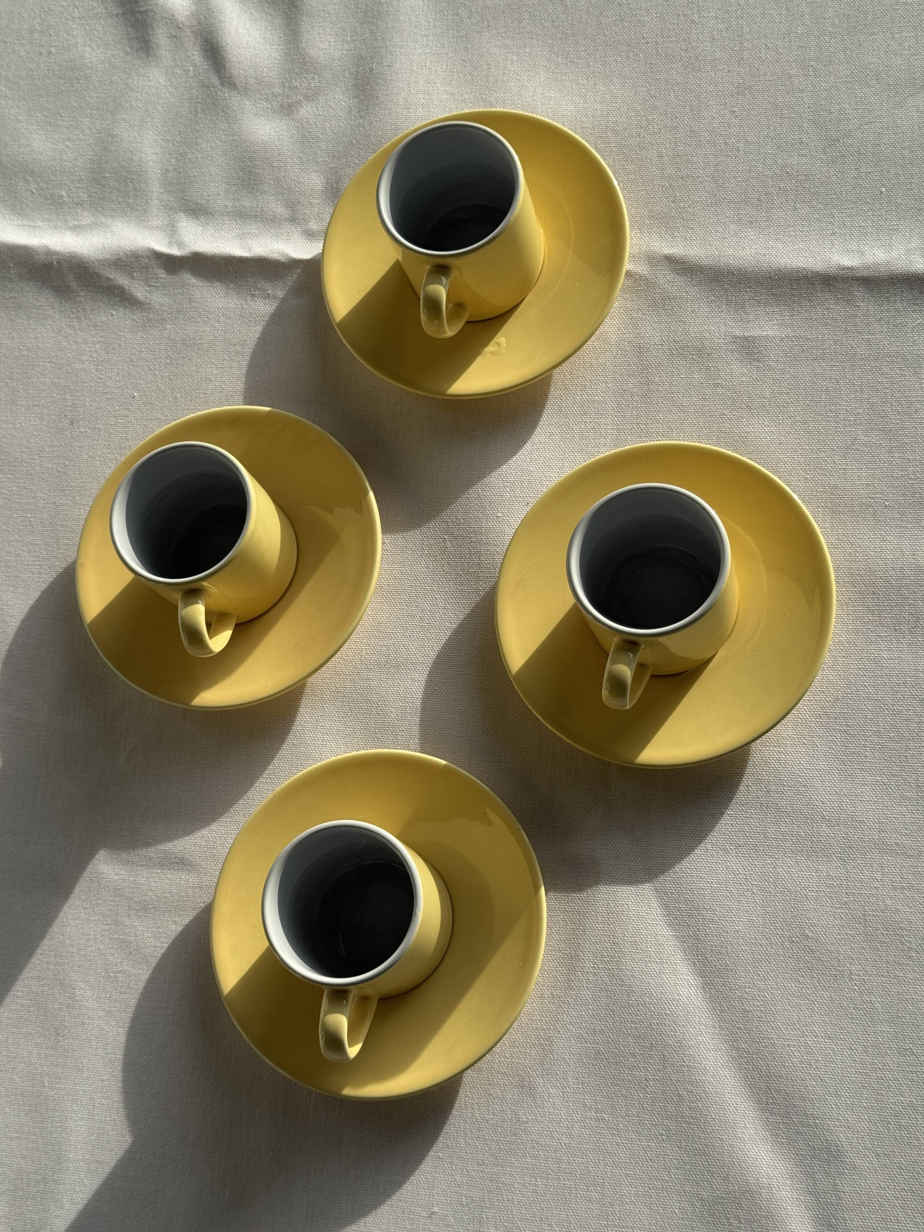 Set of 4 vintage yellow Italian espresso cups and saucers.