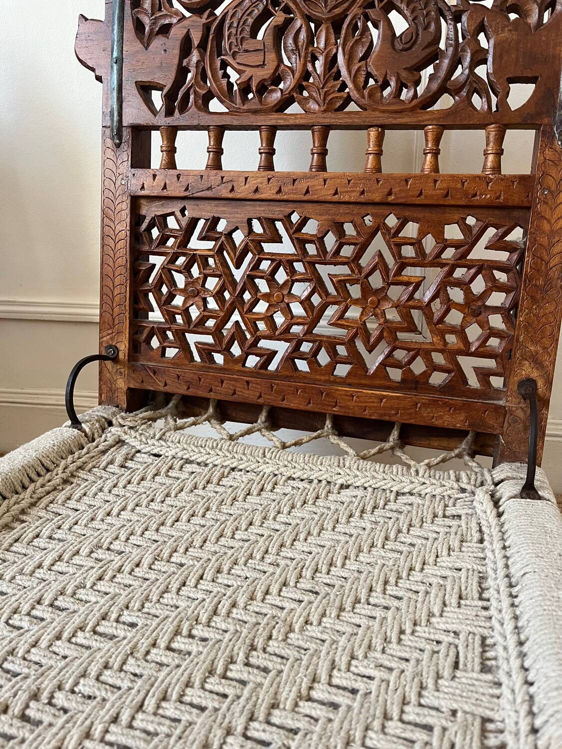 Pair of traditional Indian chairs made of carved wood and rope