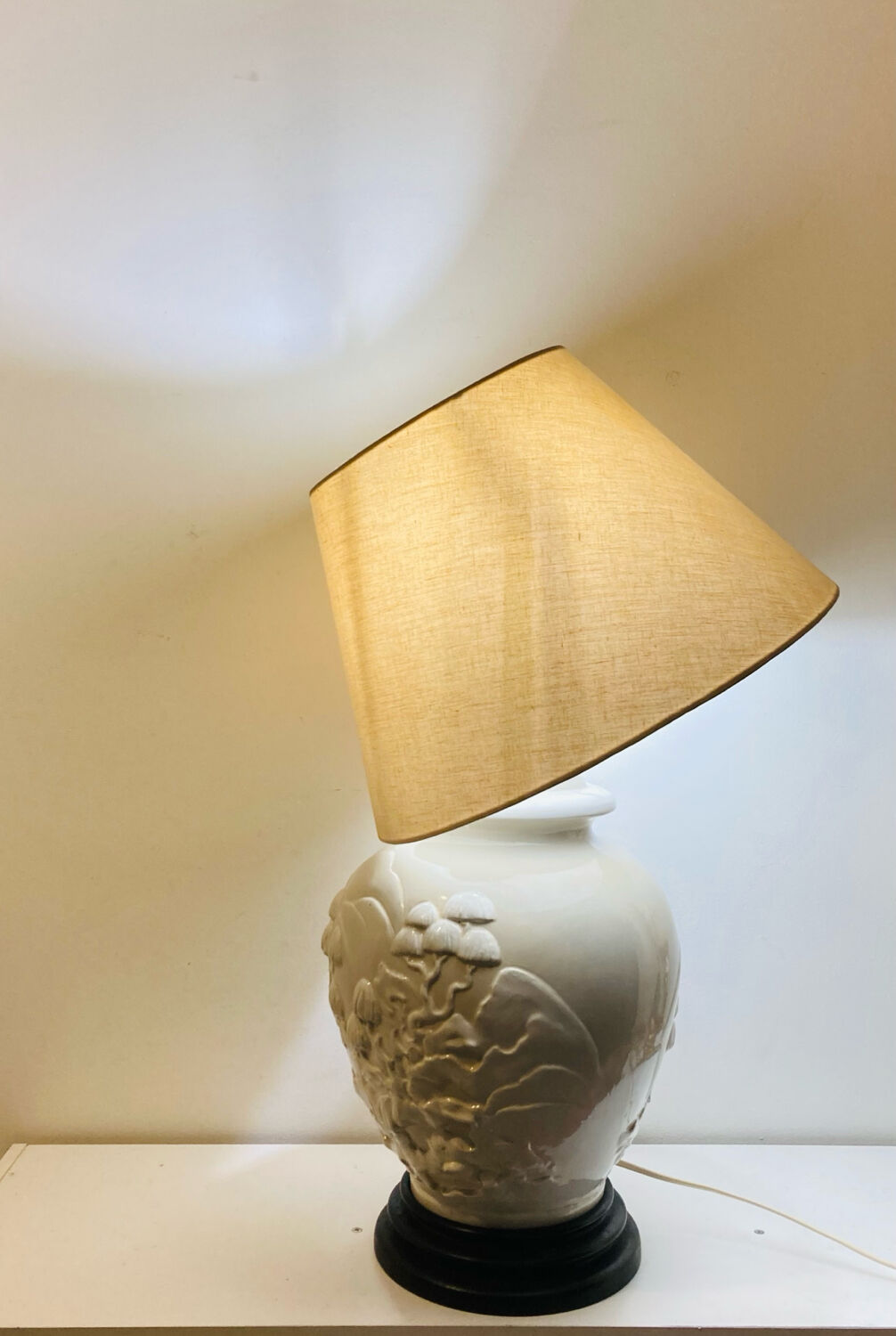 1980s ceramic table lamp with a wooden base and adjustable shade.