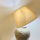 1980s ceramic table lamp with a wooden base and adjustable shade.