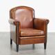 Sheepskin leather armchair in a cognac color with black piping