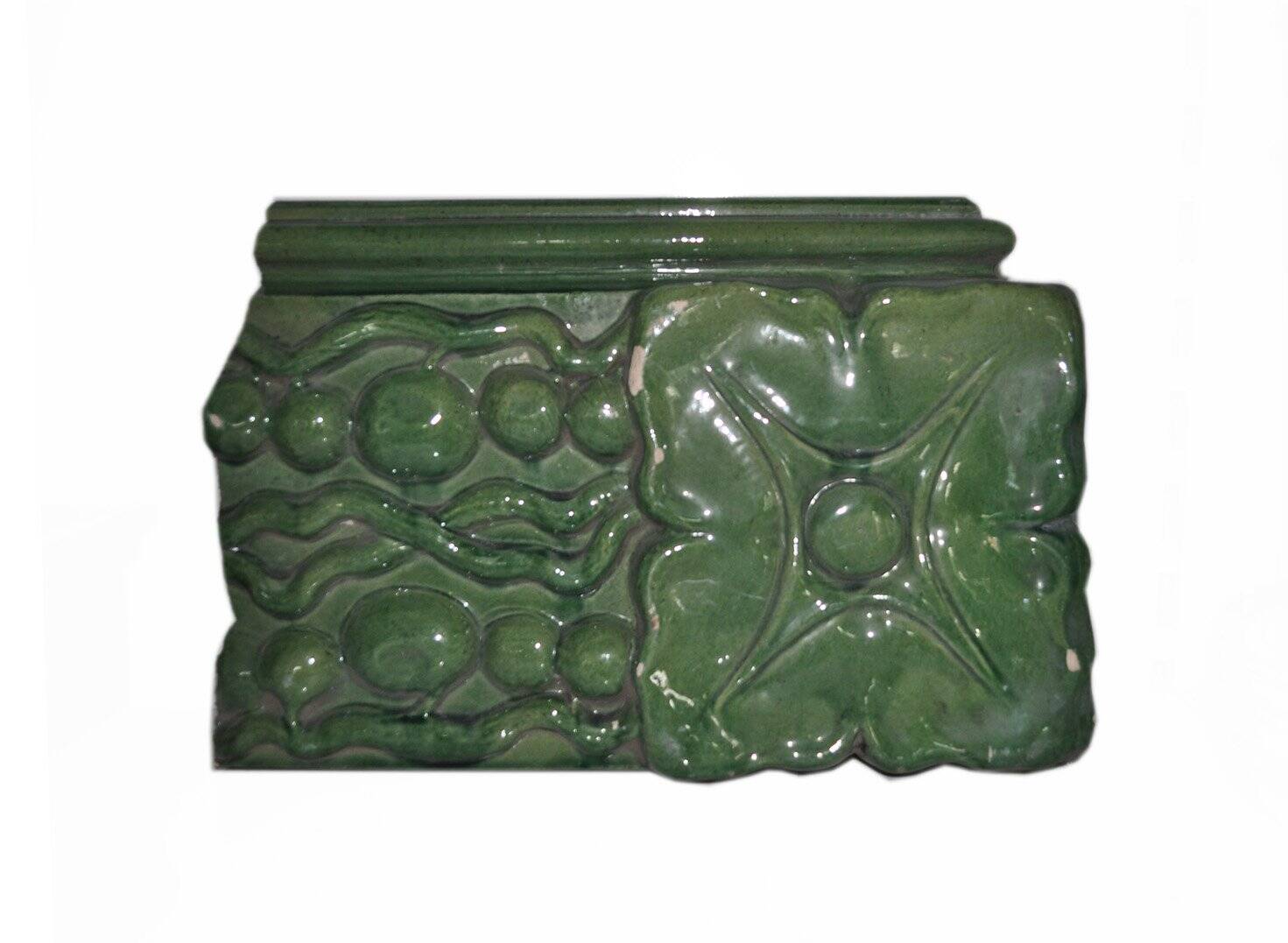 Green enamelled ceramic stove tile — finely sculpted Hungarian pattern from the late 19th century.