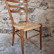 Set of 4 mid-century Italian dining chairs with woven seats, circa 1950–1970.