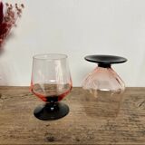 4 pink glasses with black stems