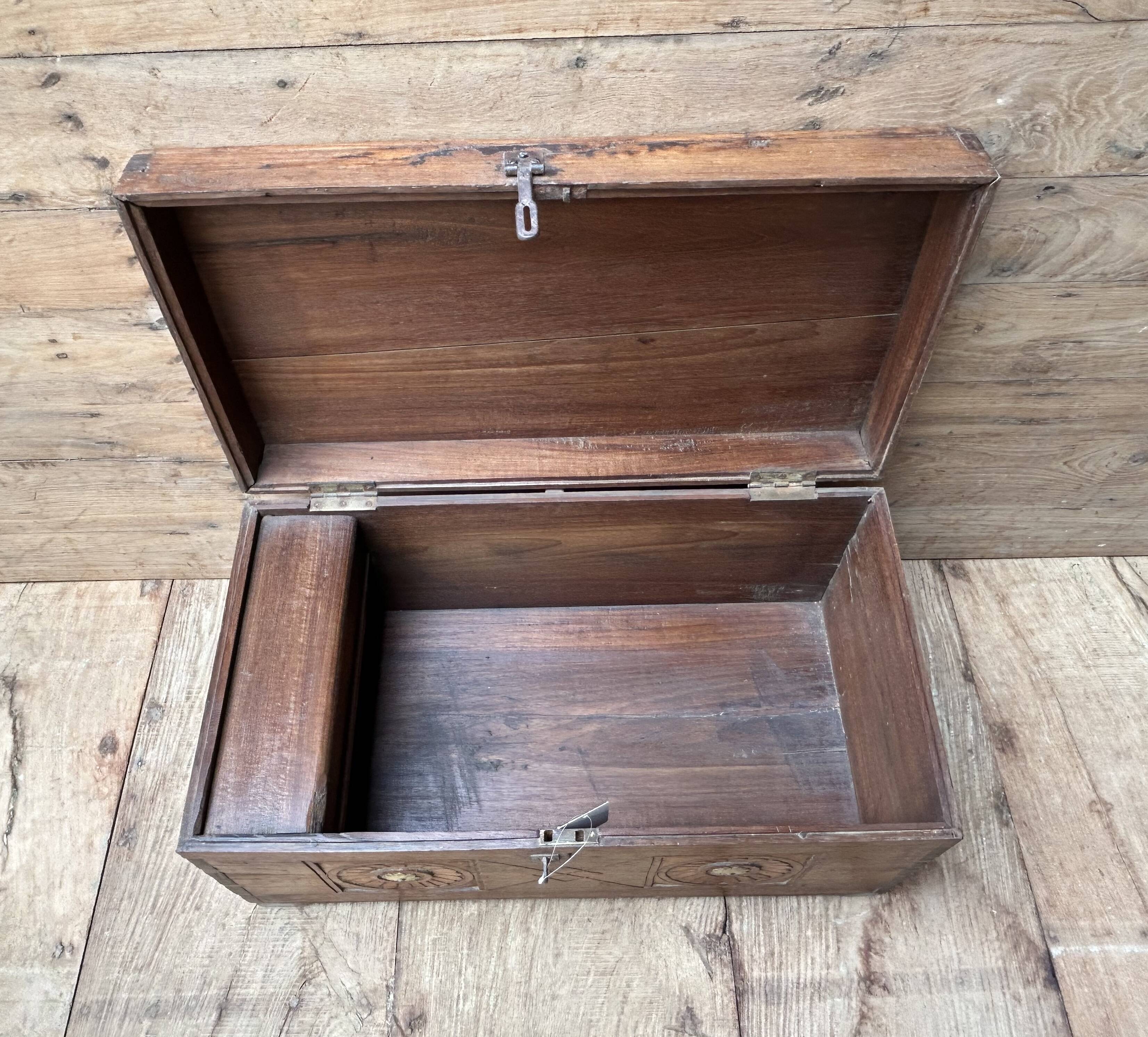 Teak chest from Burma with carved rosettes.